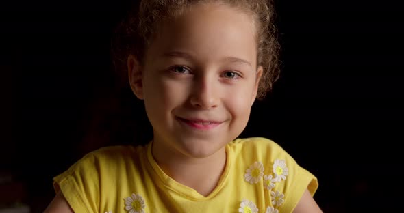 Portrait Funny Little Girl Smiling Child Looking at Camera are Sitting on the Black Background Cute