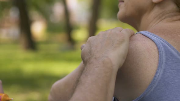 Man Creaming Shoulder of Female With Suncream, Preventing From Sunburn, Slow-Mo
