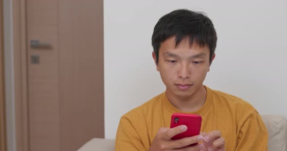 Man use of cellphone at home