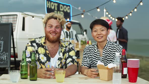 Portrait of Joyous Caucasian Man and Asian Woman on Summer Festival