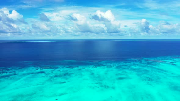 Abstract tropical ocean background. Beautiful white fluffy clouds above the coral reef where the dee