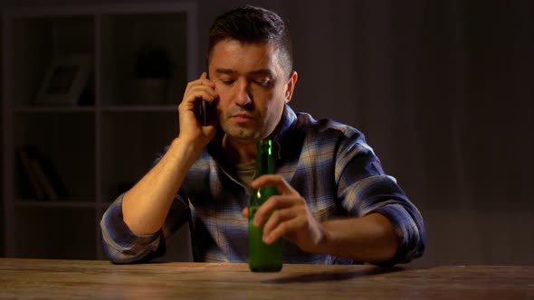 Man Drinking Beer and Calling on Smartphone 58