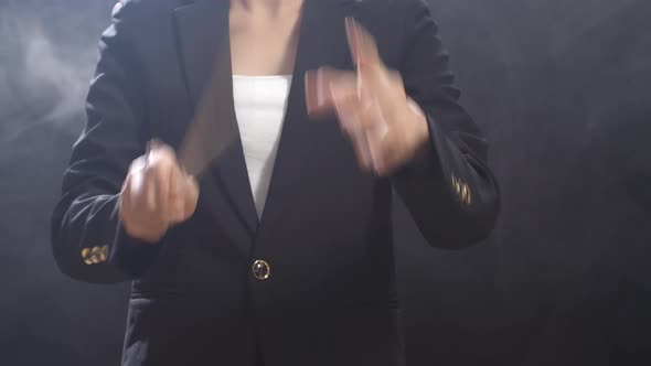 Close Up Of Conductor's Hands Holding A Baton And Moving In The Black Studio