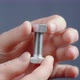 The Hand Screws the Nut on the Bolt Closeup - VideoHive Item for Sale