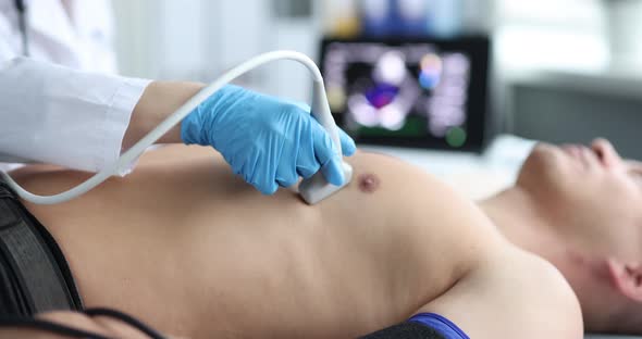 Doctor Doing Heart Ultrasound to Young Man in Clinic  Movie