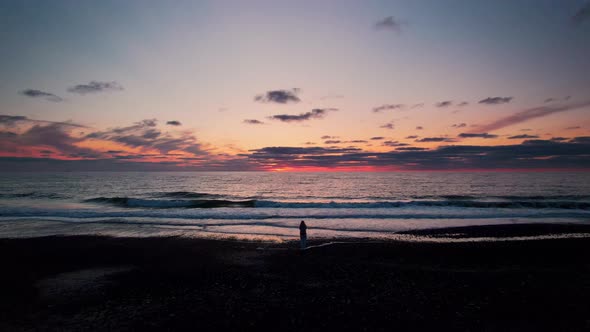 Drone Over Beach And Sea Towards Sunset Over Horizon