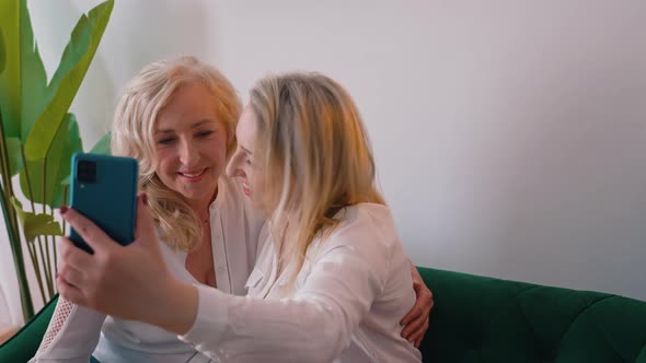 Blonde European Happy Women Taking a Selfie at Home Medium Shot Indoors Media Concept
