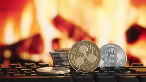 Cryptocurrency Ripple and Bitcoin on Blurring Background of Fire