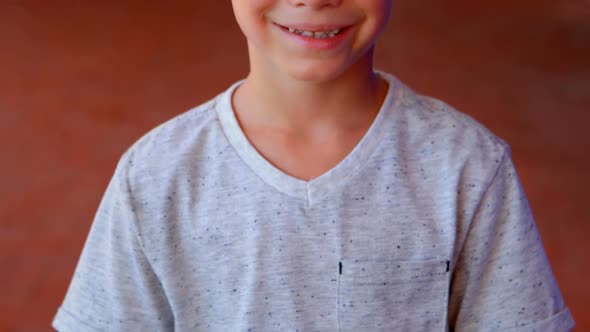 Portrait of cute schoolboy standing in corridor 4k