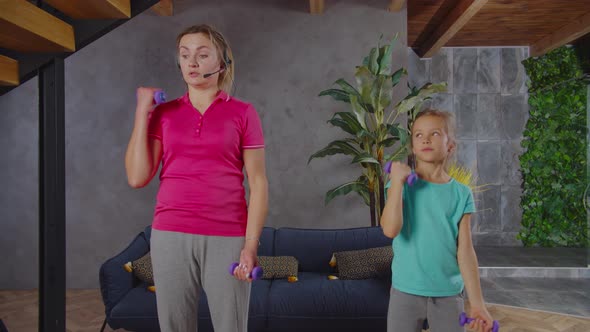 Fit Woman Talking on Phone During Workout Routine with Child