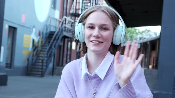 Happy Woman Looking at Web Camera Waving Hand and Greeting