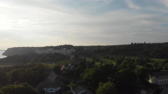 Distant aerial view filmed near dusk of the Grand Hotel on Mackinac Island, Michigan.  View shows go