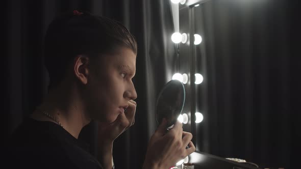 Drag Artist  Young Man Drawing New Eyebrows in Front of the Mirror