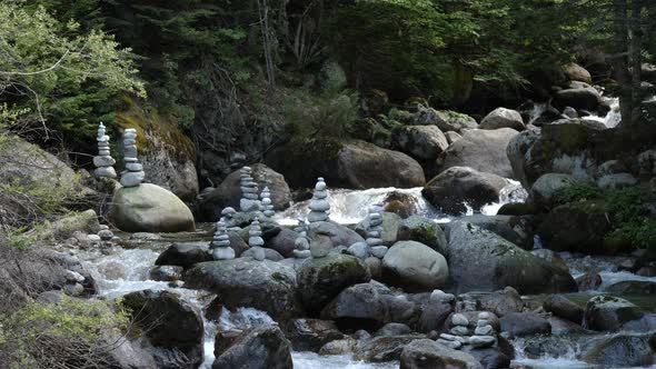 Mountain River With Stones Stacked On Top Of Each Other