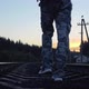 A Lonely Hooded Traveler Walking the Railway at Sunset - VideoHive Item for Sale