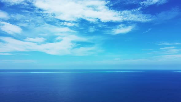 Tropical flying abstract view of a paradise sunny white sand beach and blue ocean background in 4K