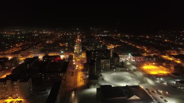 Aerial view of small night city. In the shot – the streets, the house of culture, New Year tree 03