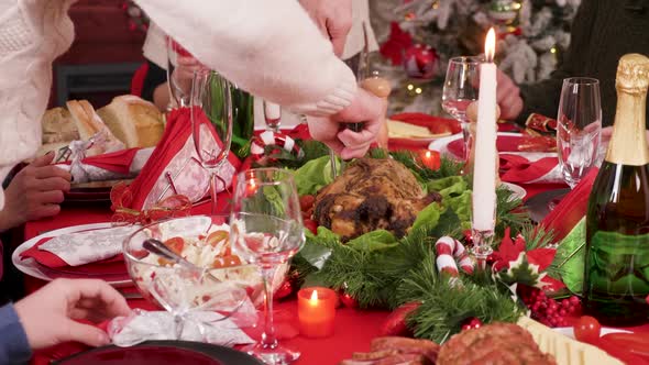 Man Slicing Turkey at Family Dinner for Christmas