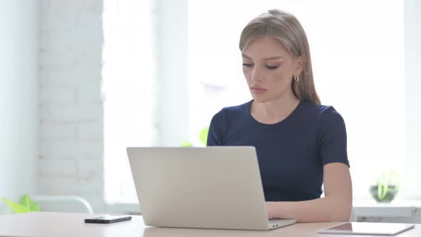 Woman Having Neck Pain While Using Laptop