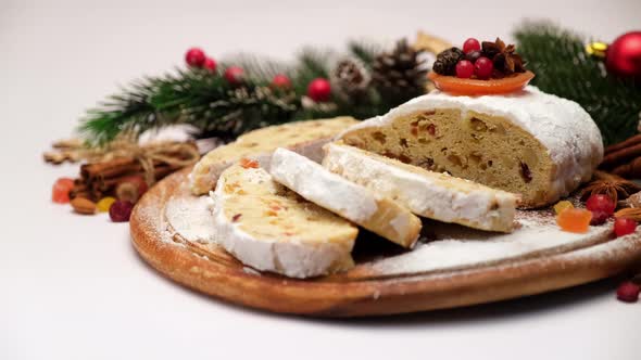 Sliced Traditional Christmas Stollen Cake with Marzipan and Dried Fruit Isolated on White Background