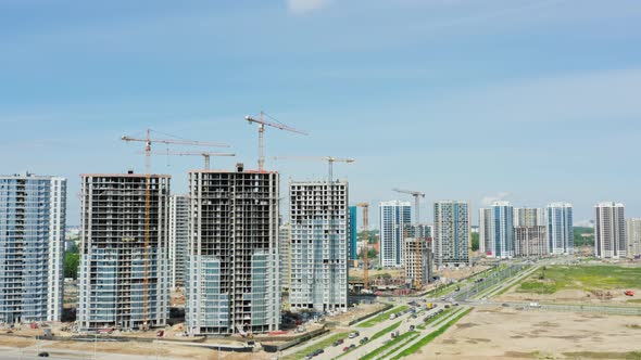 Aerial Top View Construction Site with Yellow Tower Cranes Working on Building Site in Big City