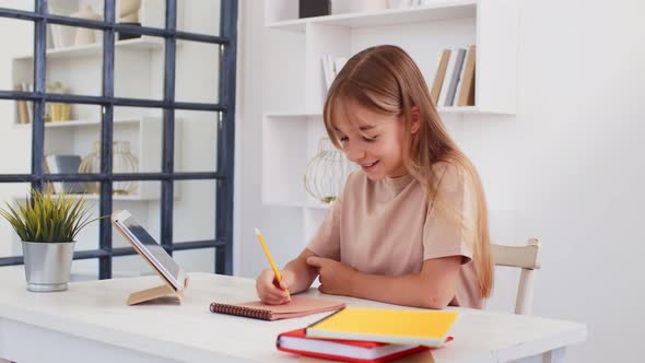 Teenage Girl Studying Online From Home with Distance Teacher