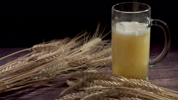 Beer and Wheat. Pouring Beer Into Glass.