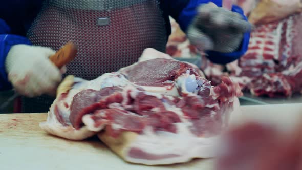 Piece of Meat Is Getting Carved By a Butcher