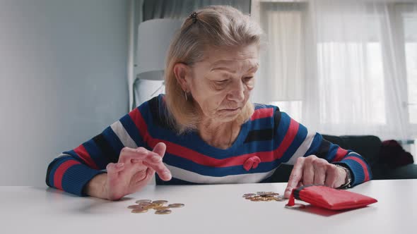 Elderly Caucasian Woman Counting Small Amount of Coins Left From Her Pension