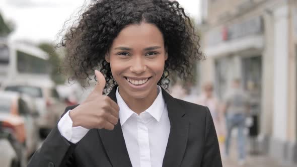 Thumbs Up By African Businesswoman Standing Outdoor By Road