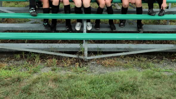 Cheering girl soccer players on bleachers