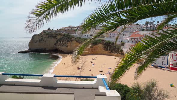 Beautiful View of the Portuguese Carvoeiro Beach in Summer with Clear Sea and Sunbathing Tourists