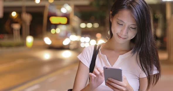 Woman using cellphone in the evening 