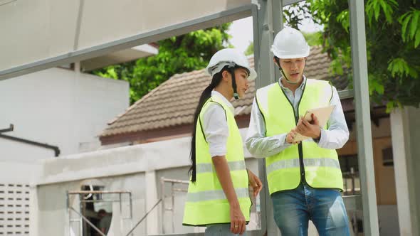 Asian colleague construction workers people wearing protective safety helmet and glasses on site.