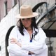 Beautiful Brunette Woman in a Felt Hat and a White Jacket Indulges in the Camera Shows Her Tongue - VideoHive Item for Sale