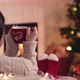 Over shoulder woman relax near fireplace cup tee in christmas woolen socks decorated tree in backg - VideoHive Item for Sale
