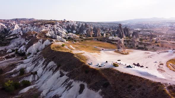 Aerial is flying sideways during Golden hour in Kizilcukur Valley, Göreme, Cappadocia.