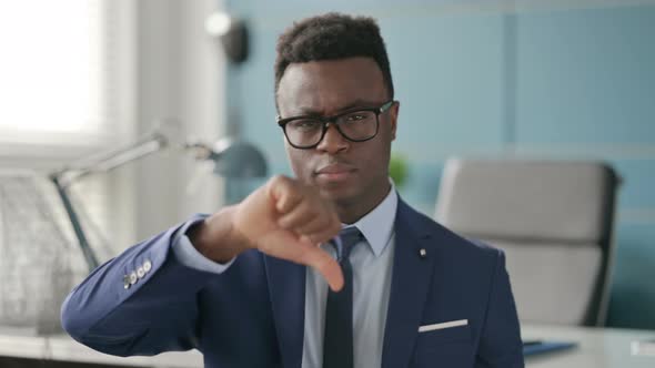 Portrait of African Businessman Showing Thumbs Down Gesture