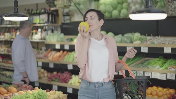 Middle Shot of Attractive Caucasian Woman Buying Vegetarian Vegetables in Grocery. Portrait of