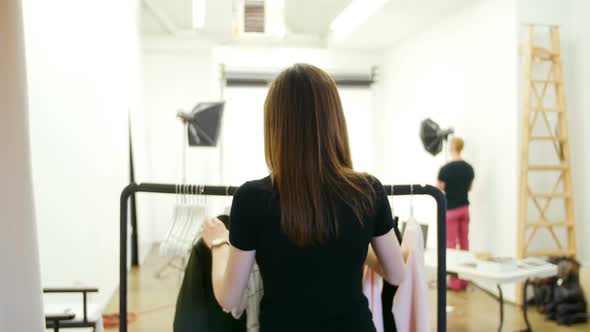 Female model trying apparel during photo shoot