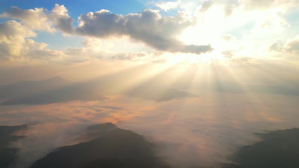 Aerial view from drone, Epic sunbeam over clouds mountains. 4K aerial shot on sunrise