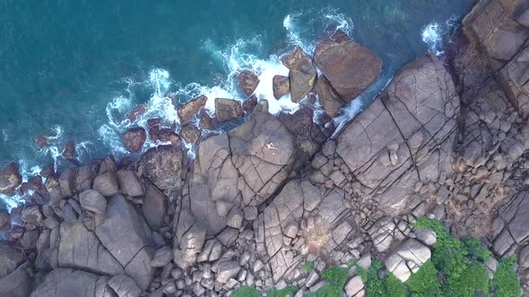 Ocean Shore with Waves and Rocks and Woman Practicing Yoga