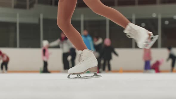 Little Girl Skater Spinning on the Public Rink