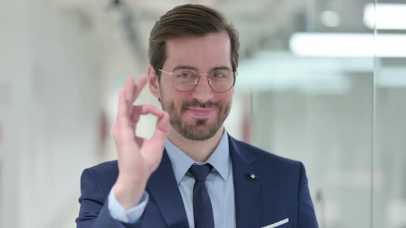 Portrait of Attractive Young Businessman Showing Ok Sign with Hand