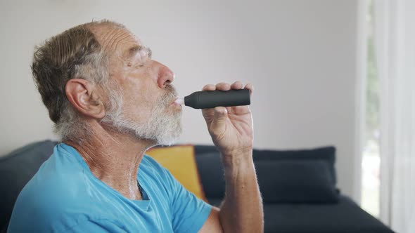 Man with Parkinson's disease using medical Cannabis in vaporizer to stop shaking