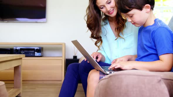 Mother and son using laptop