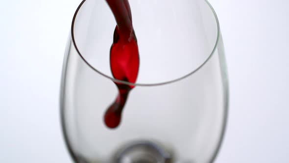 Pouring red wine into glass, Slow Motion