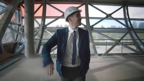 Young Man Entrepreneur Examining Industrial Building for Sale