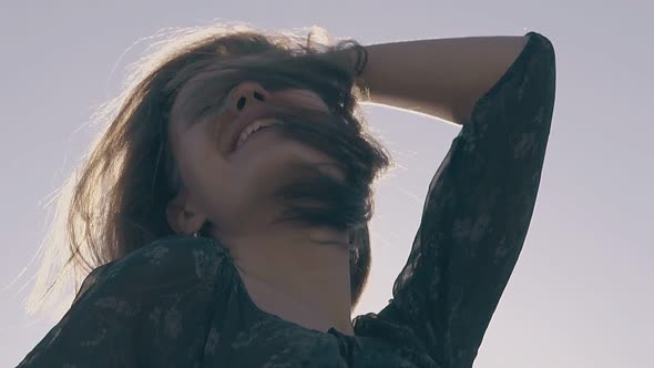 Joyful Woman Poses at Sunlight on Windy Day Slow Motion