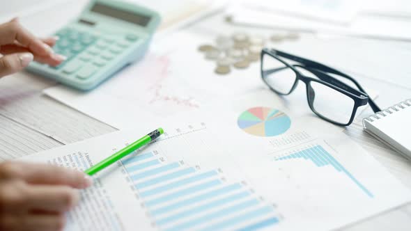 A Woman is Calculating Her Expenses for a Month